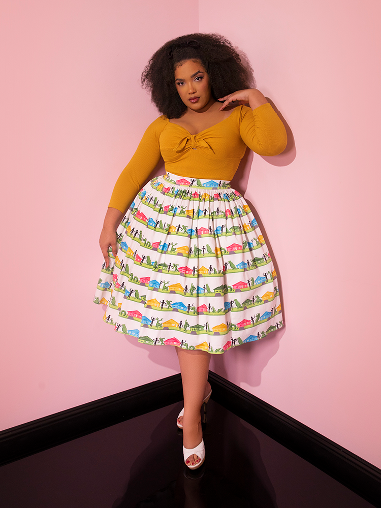 Full length shot of Ashleeta posing with one hand on her shoulder and another resting on the  EDWARD SCISSORHANDS Swing Skirt in Suburban Topiary Novelty Print.