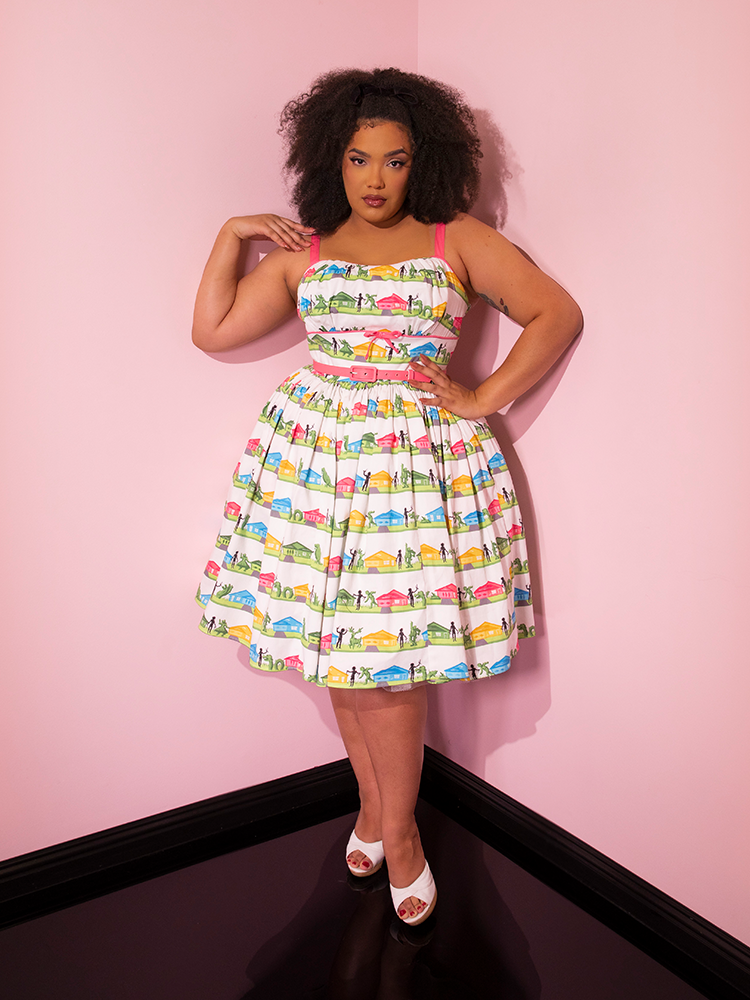 Full length shot of Ashleeta posing with one hand on her hip and the other touching her shoulder while sporting the EDWARD SCISSORHANDS Vintage Sundress in Suburban Topiary Novelty Print from Vixen Clothing.