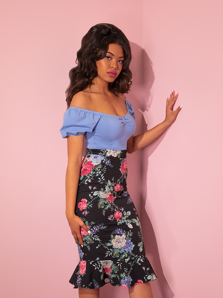 Full length shot of model wearing the Powder Puff Top in Sunset Blue with a blue floral print skirt.