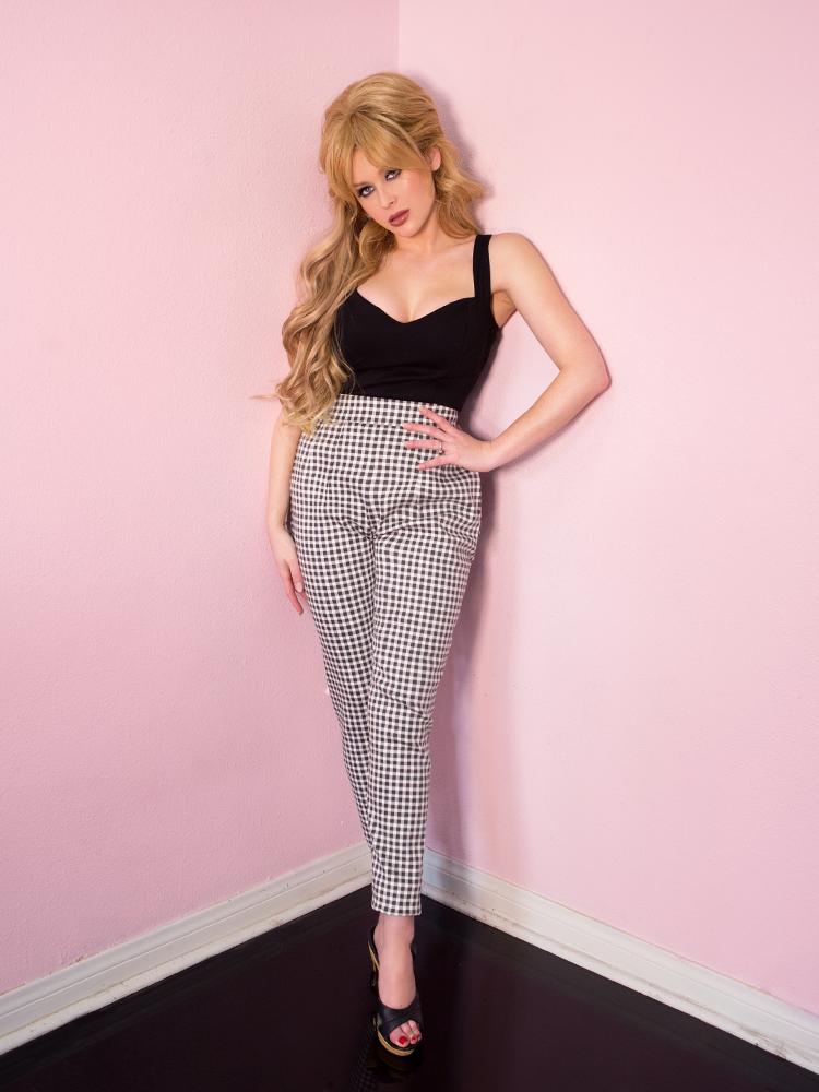 Renee Olstead wearing a black low-cut strap top paired with black gingham cigarette pants from Vixen Clothing.