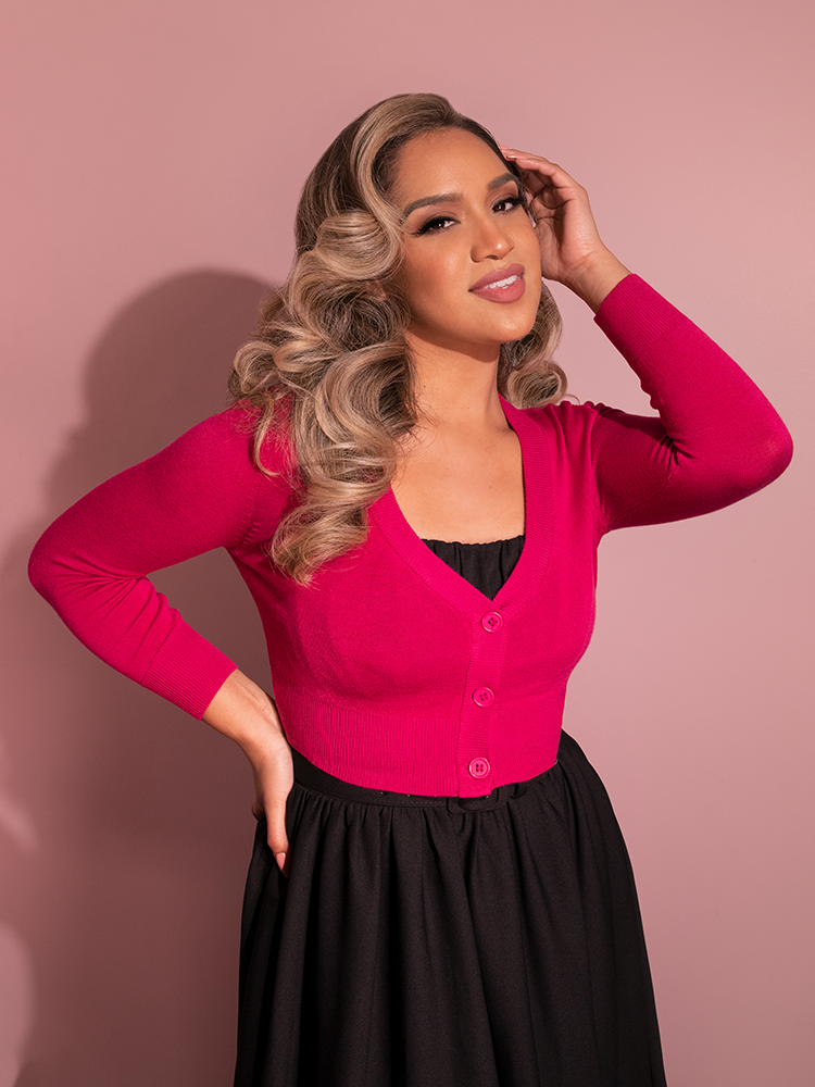 Gaby looks absolutely gorgeous as she elegantly poses to show off the Cropped V-Neck Cardigan in Magenta from Vixen Clothing.