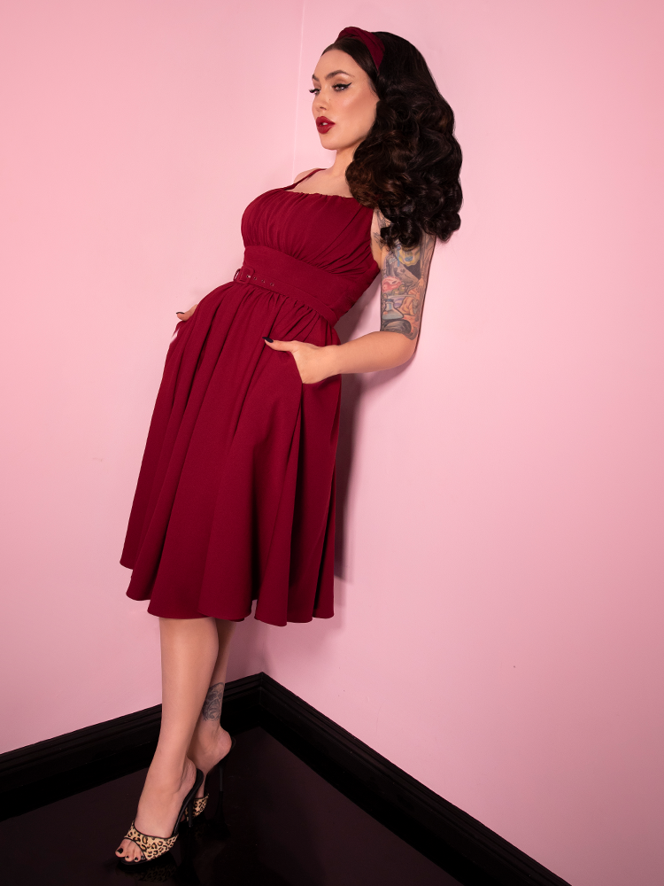 With her raven locks flowing, Micheline Pitt shows off the latest vintage style dress from Vixen Clothing - this beauty is named the Ingenue Dress in Garnet. 