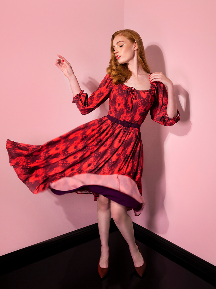 Swinging her skirt, Emily shows off the Pennywise cottage dress by Vixen Clothing.