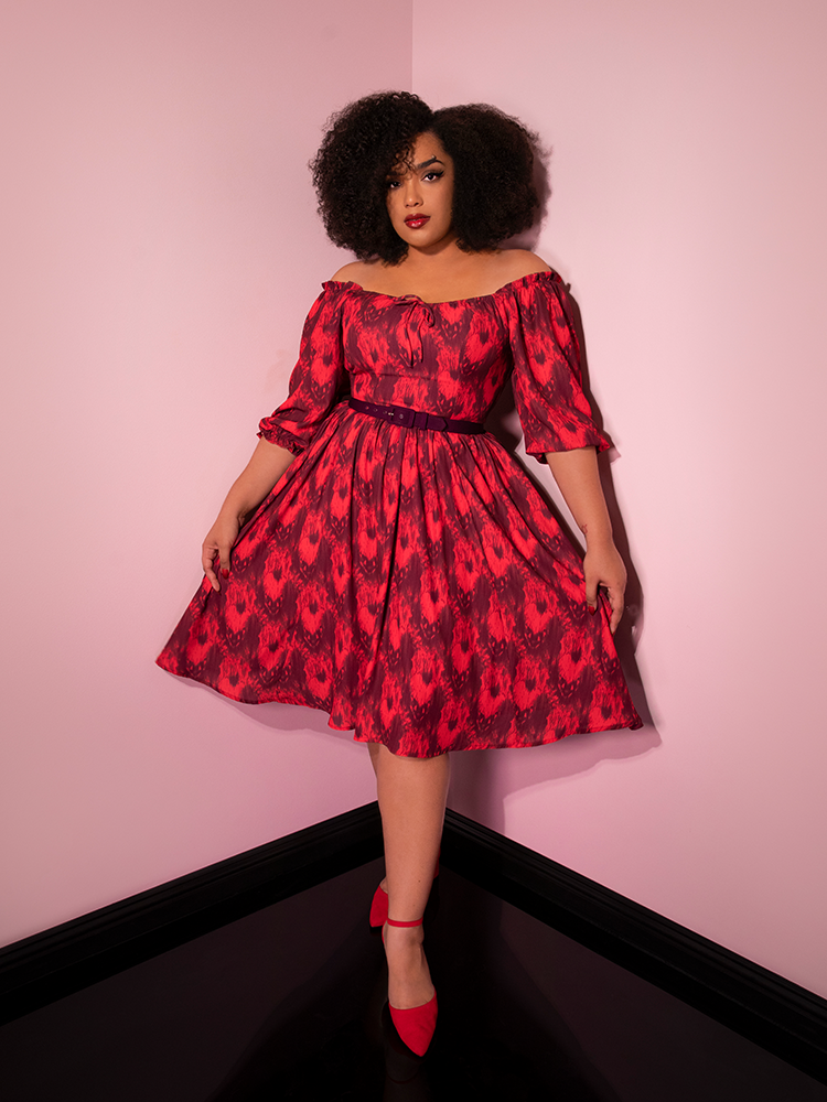 Showcasing the off shoulder detail, Ashleeta models the Pennywise cottage dress by Vixen Clothing.