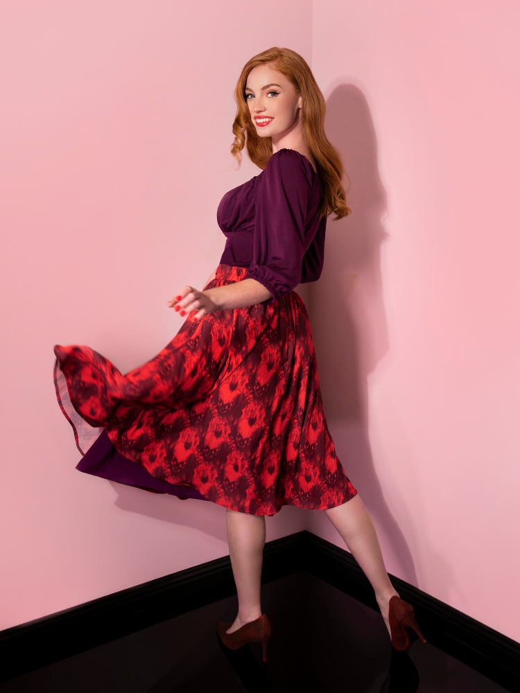 Twirling away from the camera, Emily models the Pennywise cottage skirt by Vixen Clothing.