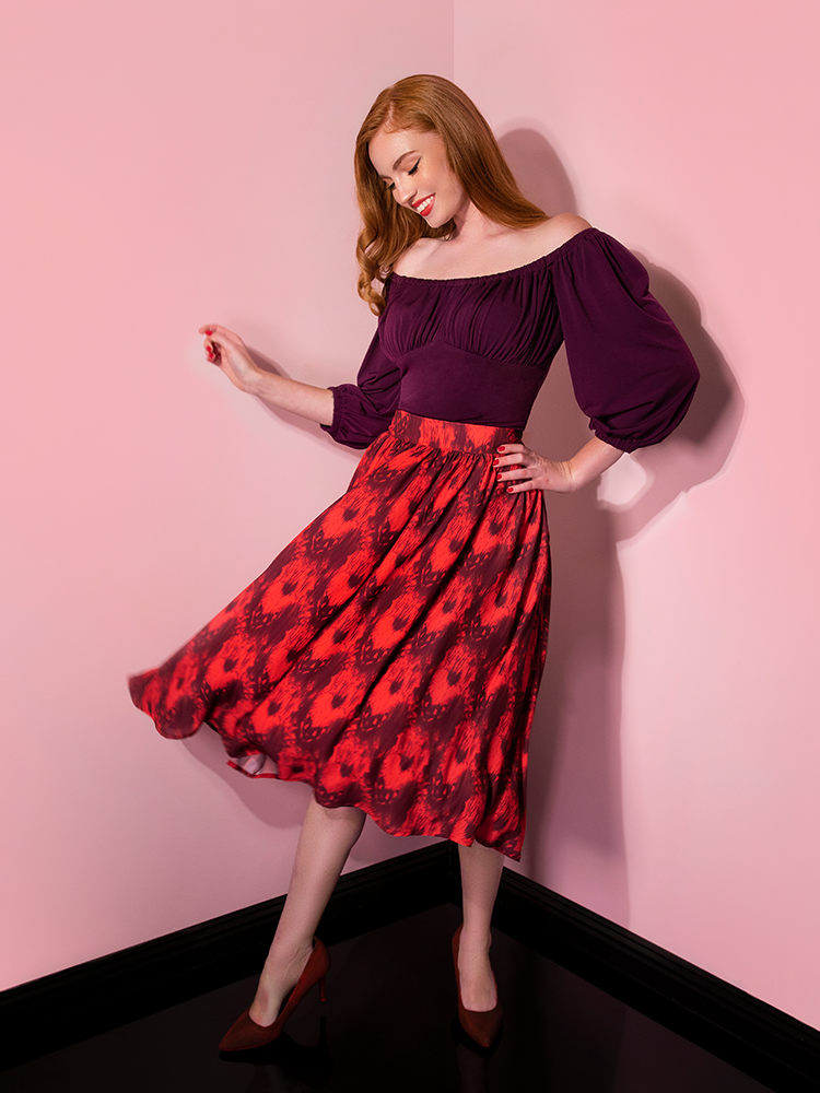 Looking down mid twirl, Emily models the Pennywise cottage skirt by Vixen Clothing.