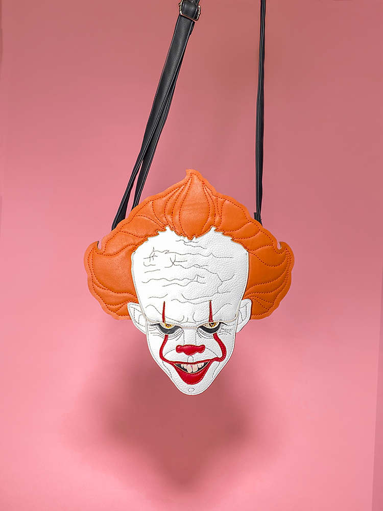 A view of the Pennywise clown cross body bag hanging by Vixen Clothing.