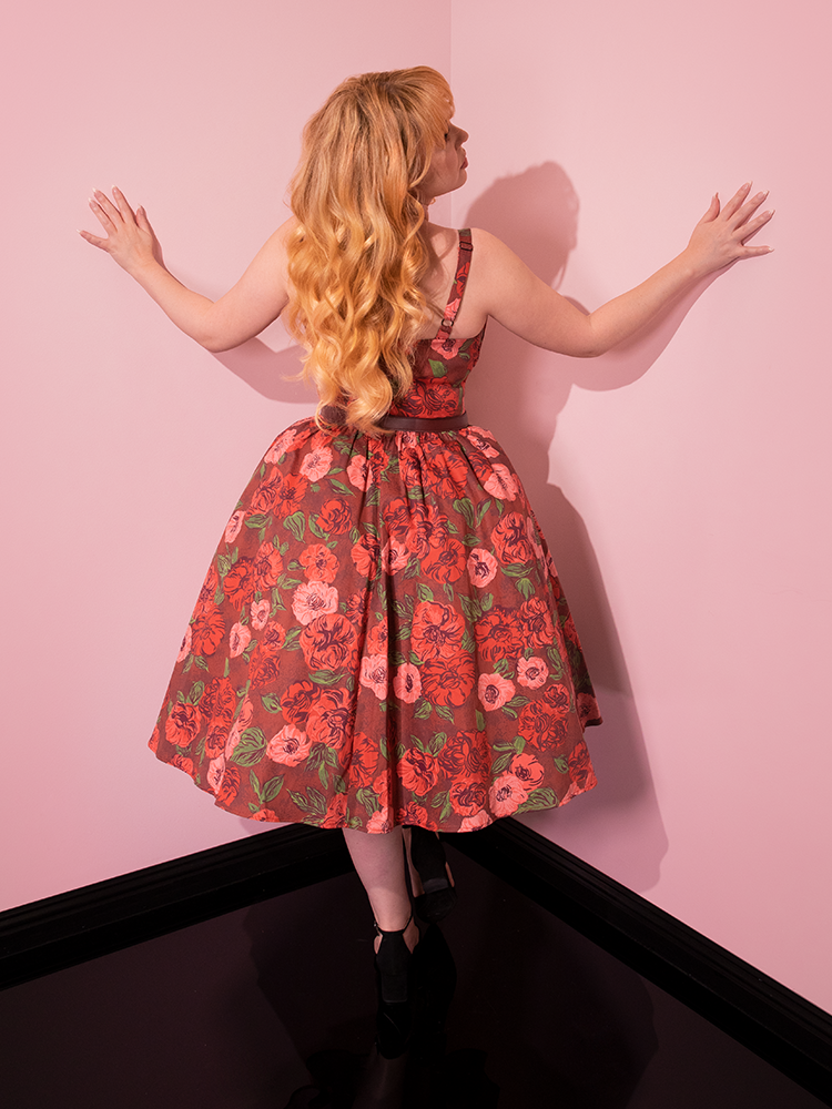 The back of the Ingenue Dress in Chocolate Rose Print being worn by female model.