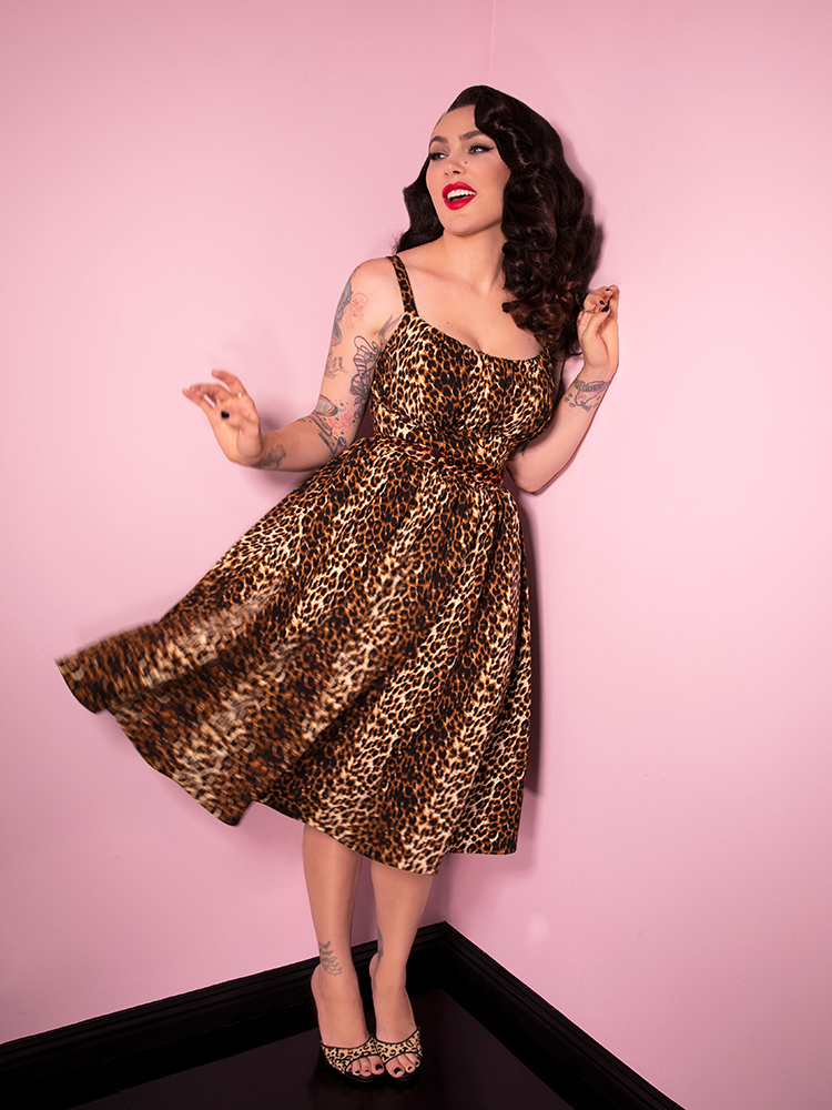 Laughing and giving her dress a twirl, Micheline Pitt is having fun in the Vintage Leopard Print Ingenue Dress from Vixen Clothing.