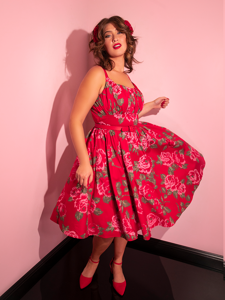 Francesca spins while wearing the Ingenue Swing Dress in Vintage Red Rose Print.