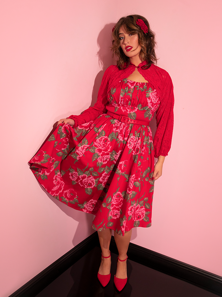 The Ingenue Swing Dress in Vintage Red Rose Print as worn by vintage clothing model from Vixen.