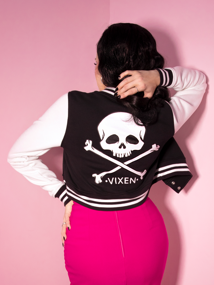 Micheline Pitt showing off the back of her hot pink retro skirt and Vixen Letterman Jacket.