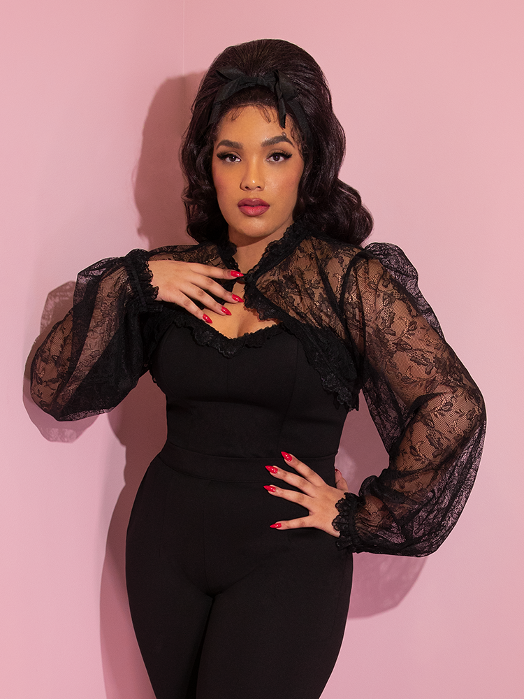 Close-up shot of Ashleeta in the Vixen Vintage Lace Bolero in Black paired with black pants.