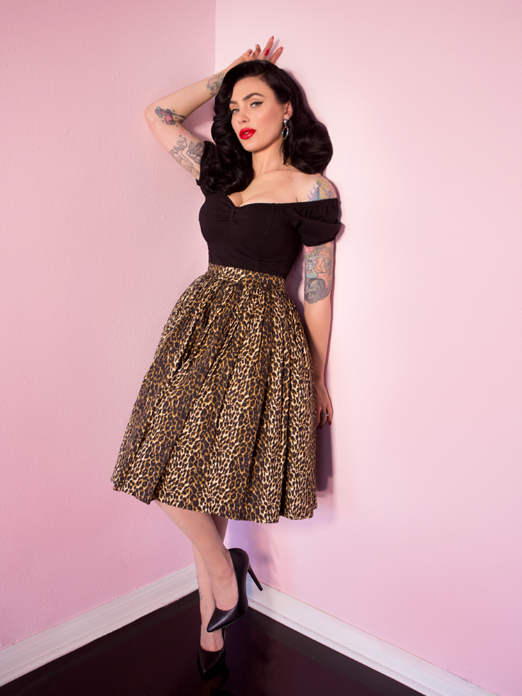Full length shot of Micheline Pitt wearing a retro inspired outfit - swing skirt in wild leopard print along with vintage style black top.