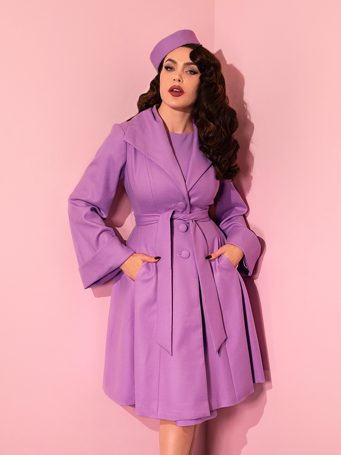 Micheline Pitt poses in the all new The Lili Coat in Lilac from Vixen Clothing.