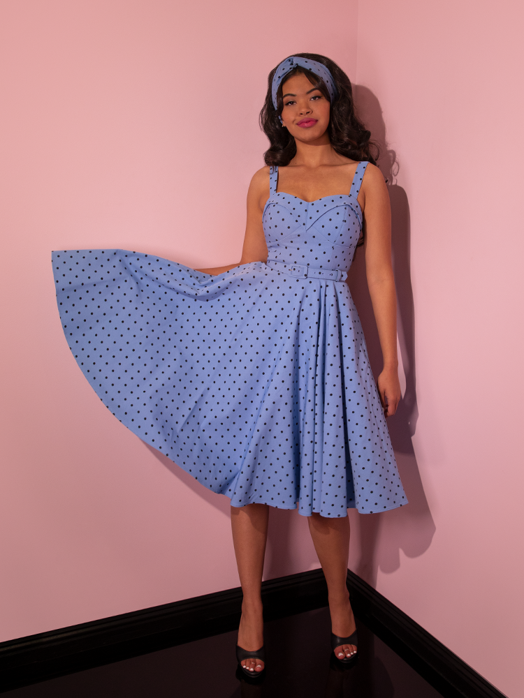 Full length shot of model wearing the Maneater Swing Dress in Sunset Blue Polka Dot.