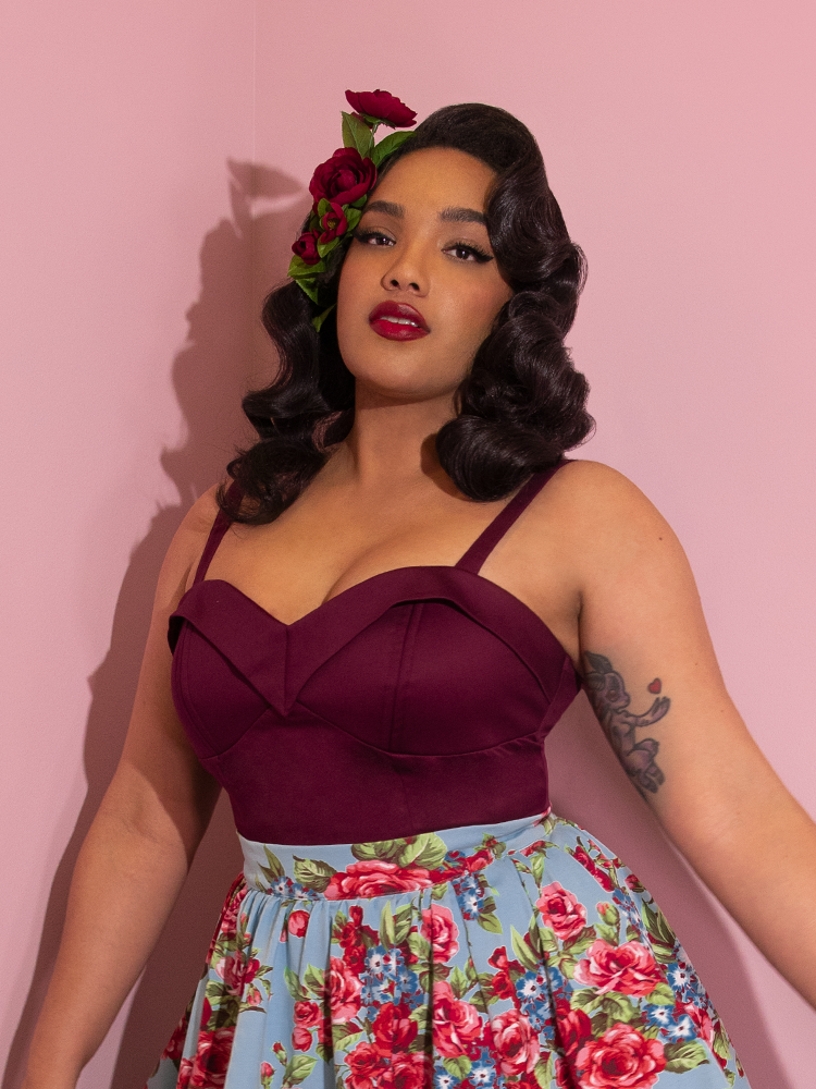 Closeup shot of Ashleeta in the Maneater Top in Dark Berry paired with a floral skirt.