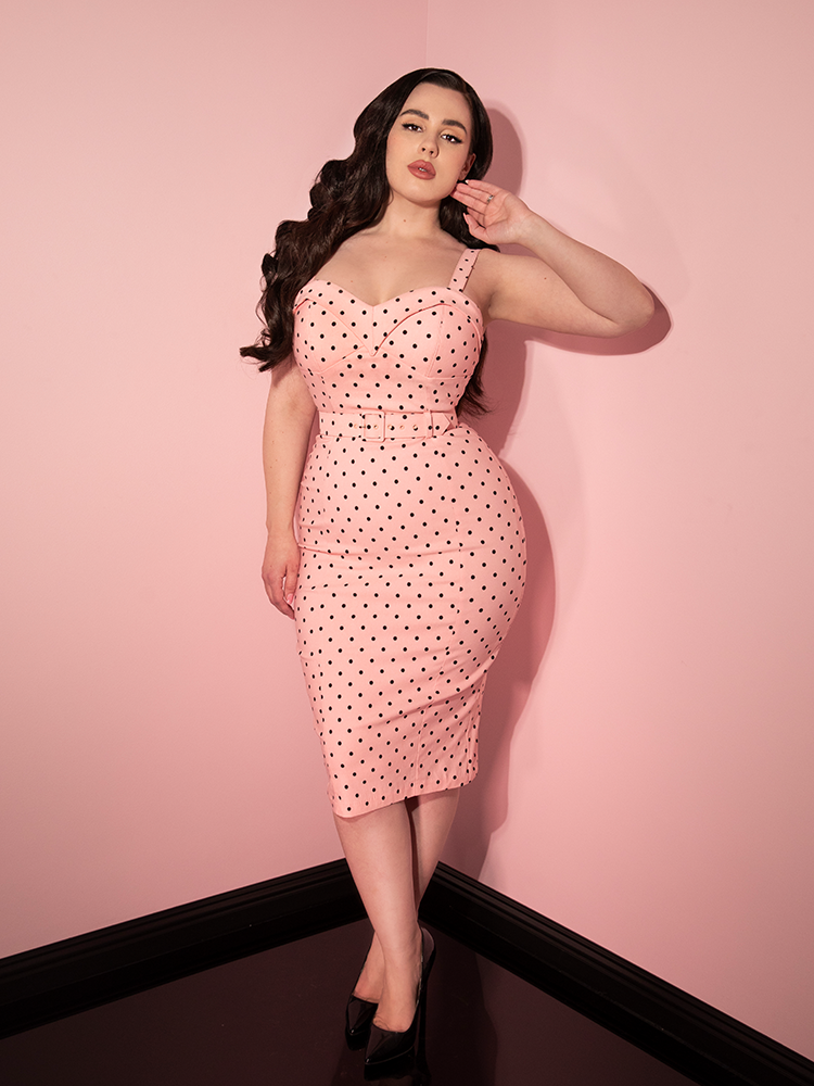 Rachel Sedory posing in the Maneater Wiggle Dress in Rose Pink Polka Dot dress.