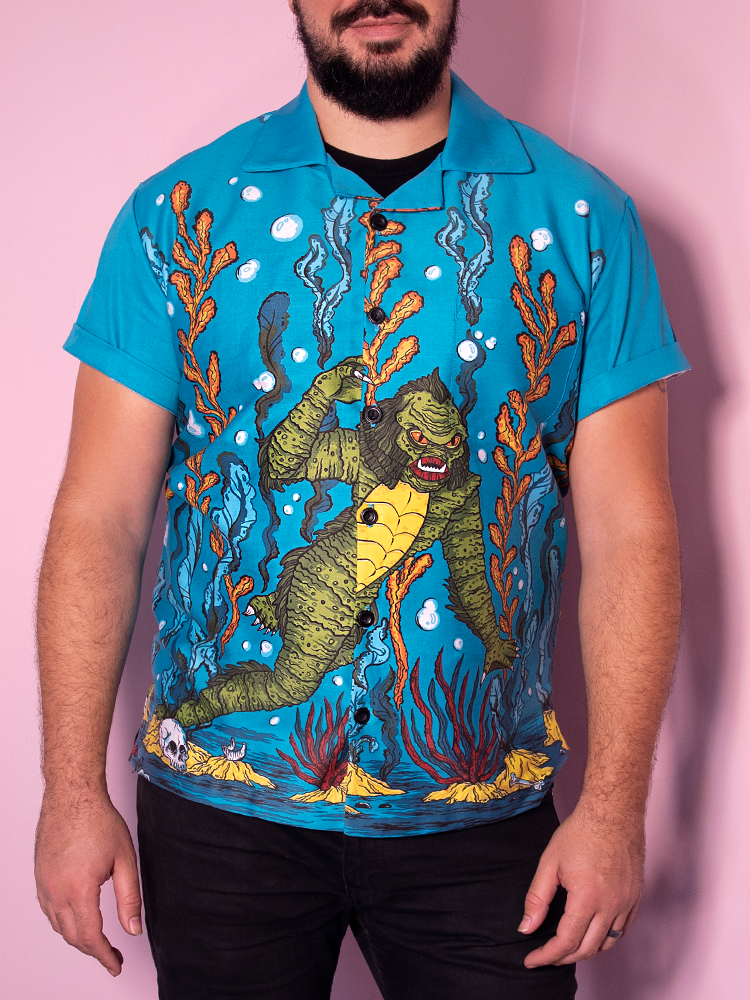 Straight on shot of male model wearing the retro shirt from Vixen Clothing featuring the swamp creature in the ocean print.