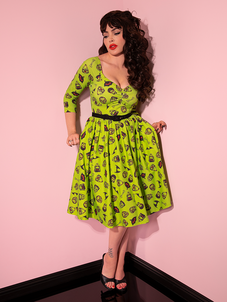 Micheline Pitt pulling out the sides of the skirt on the Wicked Swing Dress in Vintage Monster Mash Print.