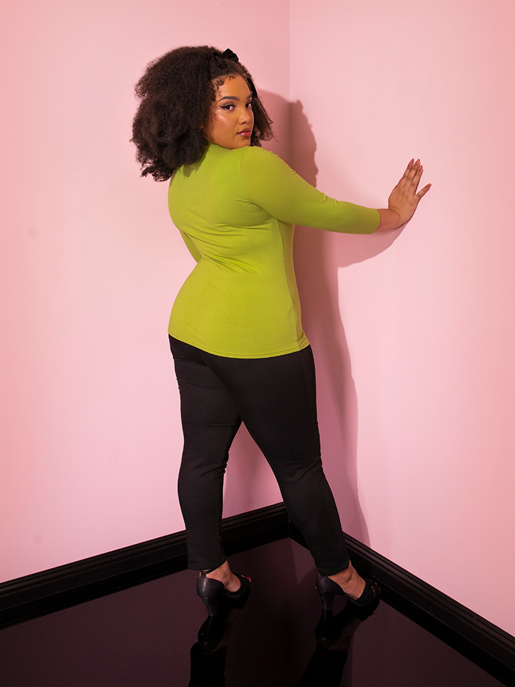 Back view of the  Bad Girl 3/4 Sleeve Top in Avocado Green from Vixen Clothing.