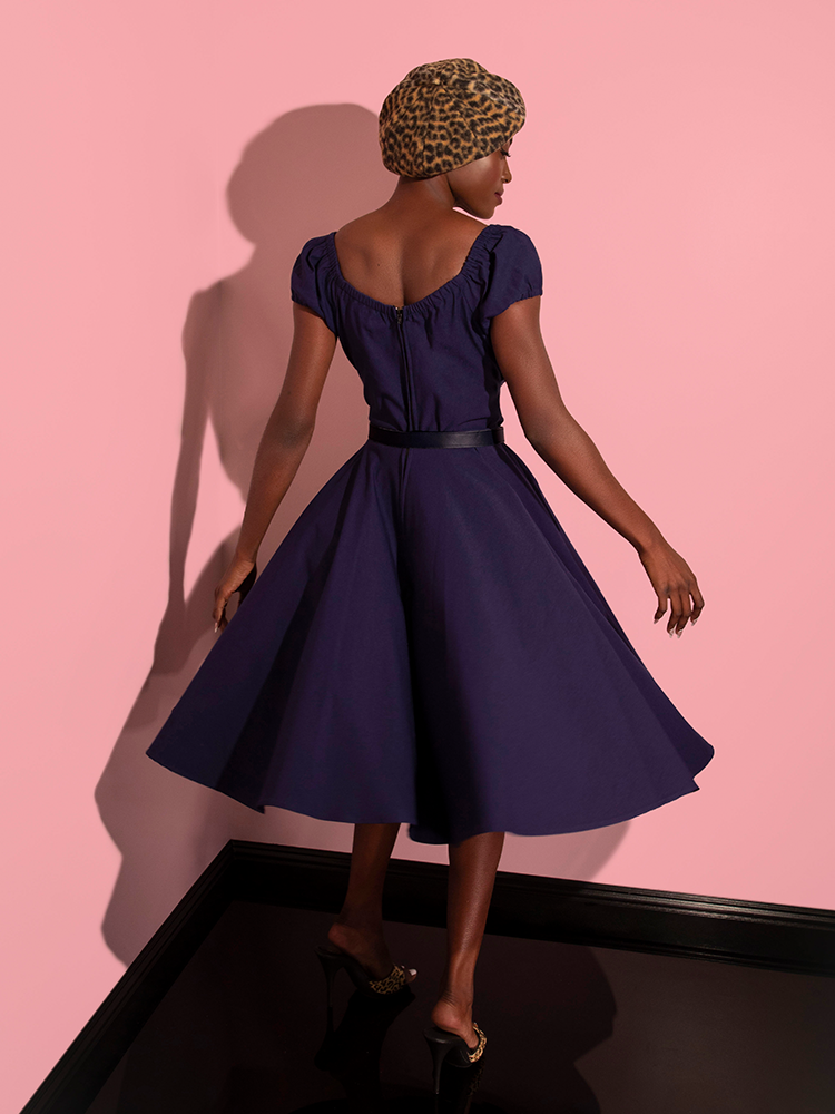 The back of the Peasant Swing Dress in Navy from retro dress brand Vixen Clothing.