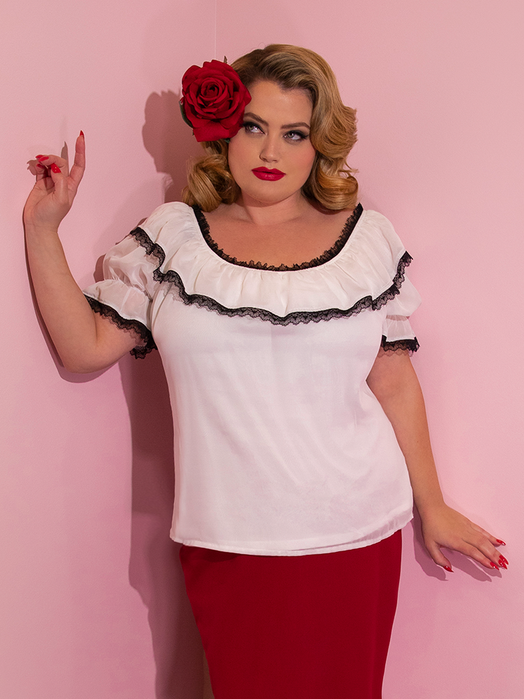 Blondie shows how the Vixen Chiffon Peasant Top in White with Black Lace can be worn outside of your bottoms.
