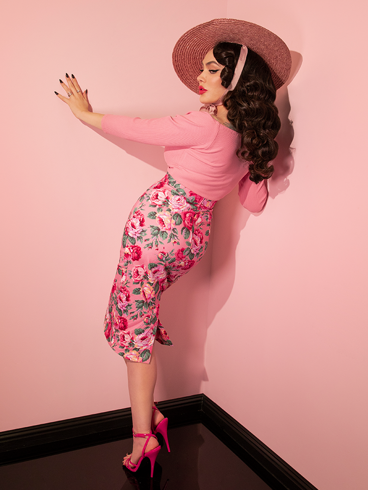 Micheline Pitt turned away from the camera to show off the back of the Vixen Pencil Skirt in Pink Rose Print.