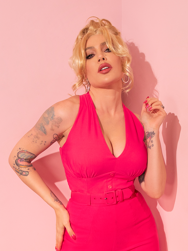 Radiating retro elegance, a beautiful female model showcases the Candy Pink True Romance Top, a rare gem plucked from the vintage gems curated by Vixen Clothing.