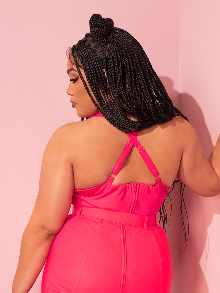 In a nostalgic tableau, a ravishing femme fatale adorns the True Romance Top in Candy Pink, a timeless creation sourced from the retro treasure trove of Vixen Clothing.