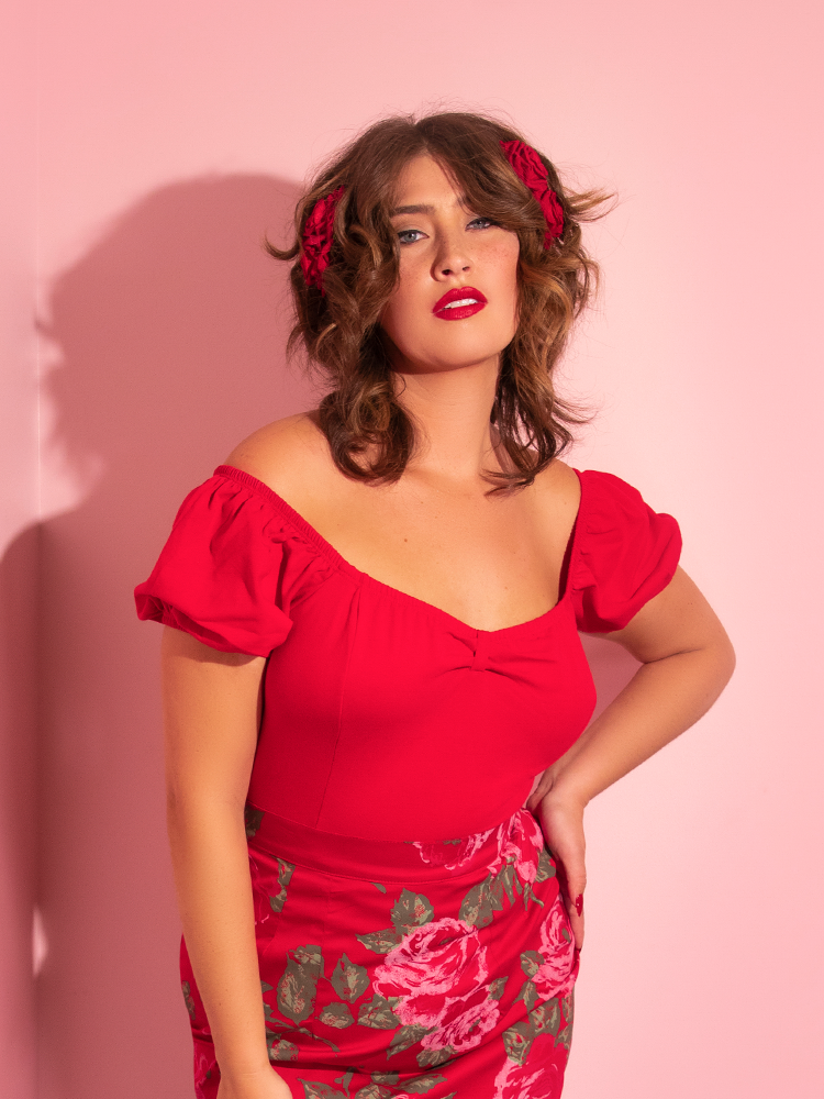The Powder Puff Top in Red being worn be a female retro clothing model.