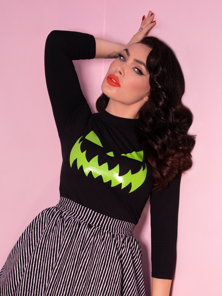 Micheline Pitt, model and owner of Vixen Clothing, shows off the Black Pumpkin King Glow in the Dark 3/4 Sleeve Top from Vixen Clothing.