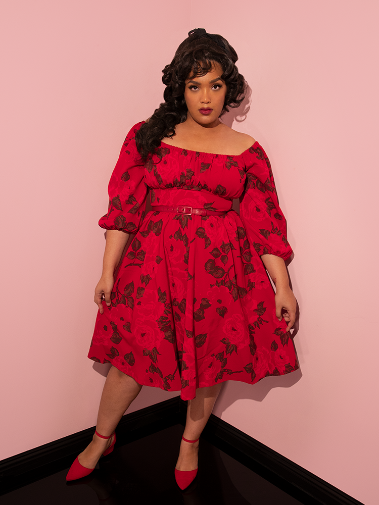 Ashleeta stares directly into the camera while modeling the all-new Vacation Dress in Vintage Red Rose Print.