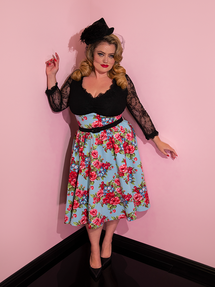 Blondie modeling the Romantique swing dress paired with a black feather hat.