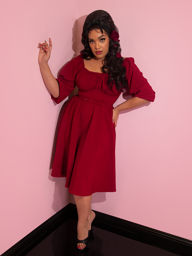 Full length shot of Ashleeta wearing the Vacation Dress in Ruby Red from Vixen Clothing.