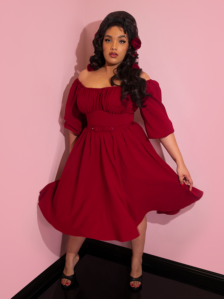 Ashleeta swinging the skirt of her Vacation Dress in Ruby Red from Vixen Clothing.