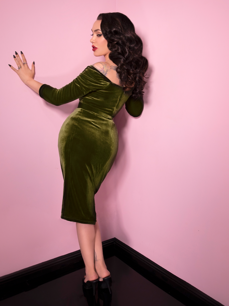 Backshot of Micheline Pitt showing off the Starlet Wiggle Dress in Olive Green from Vixen Clothing.