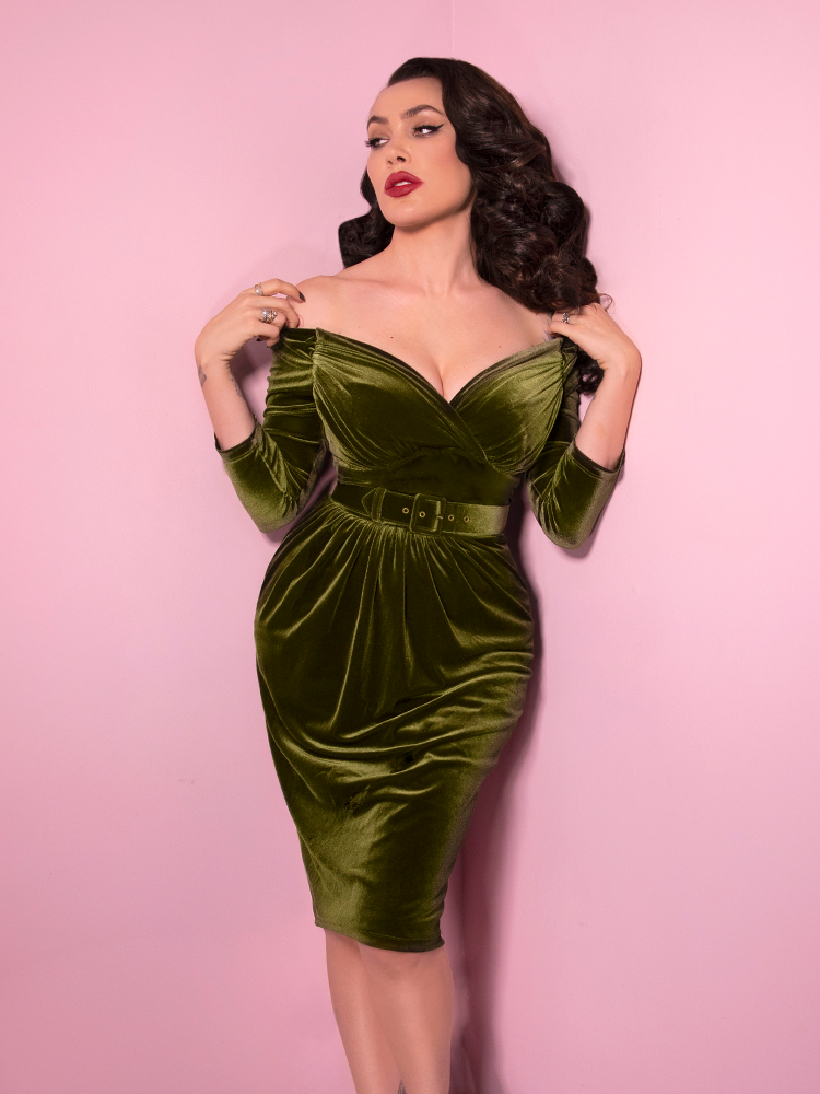 Looking like a modern day bombshell, Micheline Pitt shows off the Starlet Wiggle Dress in Olive Green from Vixen Clothing.