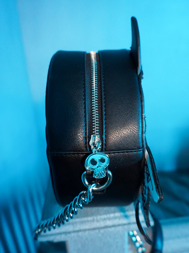 Isolated product shot of the skull charm on the BEETLEJUICE™ Sandworm Crossbody Bag.