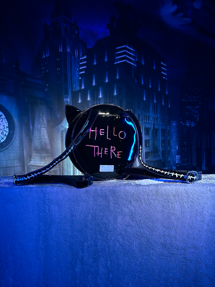 The back of the BATMAN RETURNS™ Shreck’s Cat Backpack reveals the hot pink "HELLO THERE" lettering.