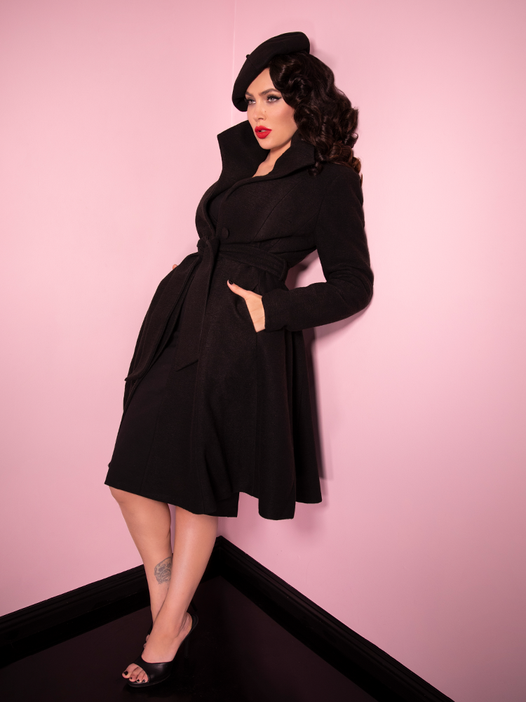 Full length shot of Micheline Pitt looking mysterious and stunning in the black Starlet Swing Coat and matching beret and shoes.
