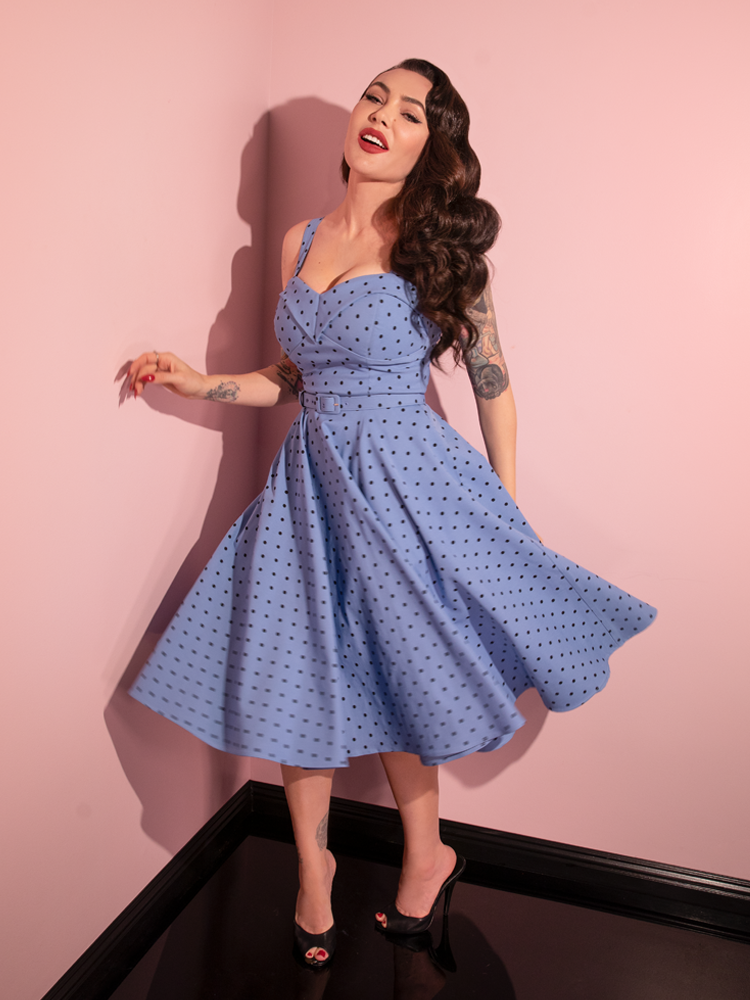 Micheline Pitt swings around in the Maneater Swing Dress in Sunset Blue Polka Dot from retro dress company Vixen Clothing.