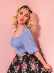 The Vacation Blouse in Sunset Blue being worn by Vixen model, Sofia. 