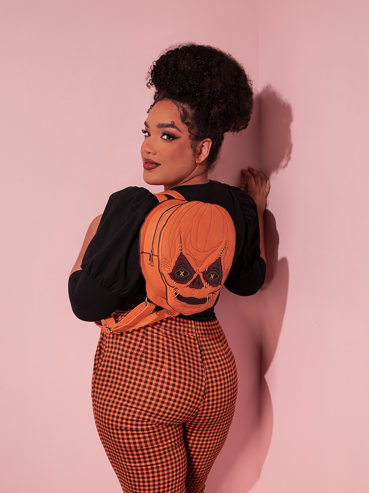 Female model wearing the TRICK R TREAT™ Sam Backpack With a retro style outfit.