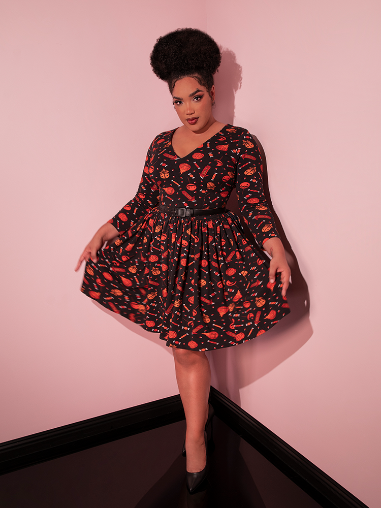 The TRICK R TREAT™ Deadly Swing Dress in Candy Corn Novelty Print as worn by female model from Vixen Clothing.