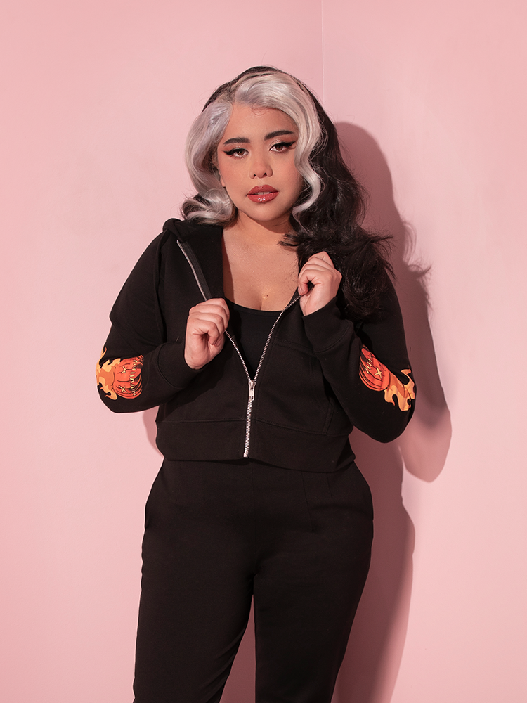 The TRICK R TREAT™ Sam Cropped Hoodie from retro clothing brand Vixen Clothing being worn by silver and black haired female model.