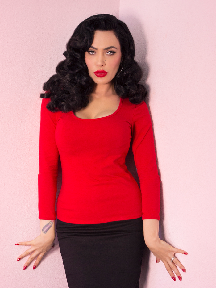 Micheline Pitt modeling the Troublemaker top in red untucked by Vixen Clothing.