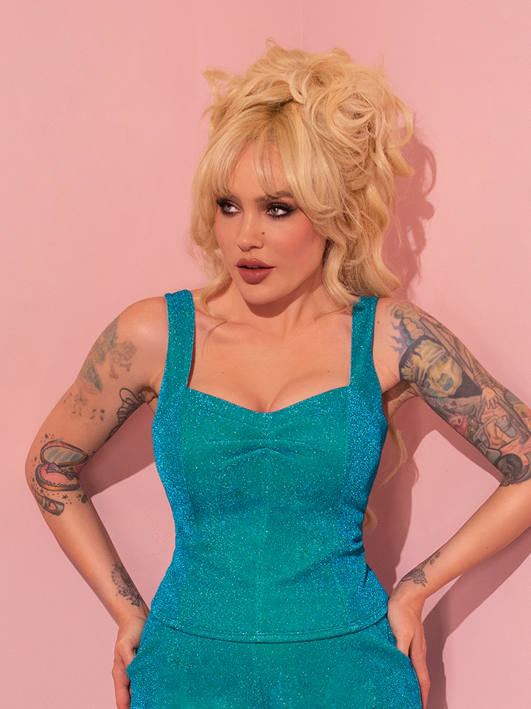 The retro fashion brand, Vixen Clothing, has created an all new Vamp Top in Turquoise Lurex that showcases the female model's stunning sex appeal.