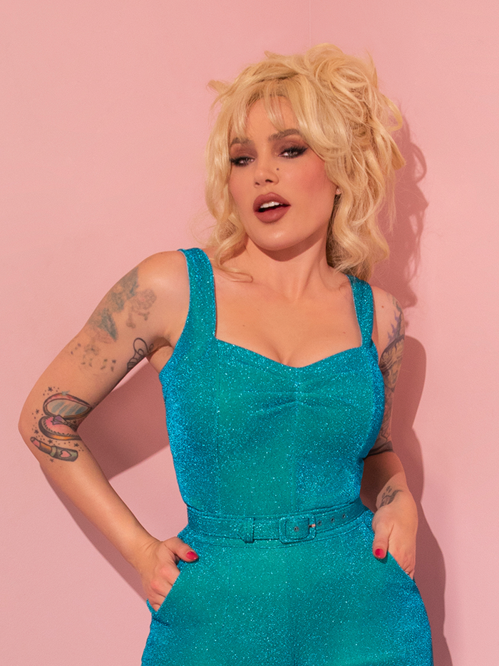 The Vixen Clothing retro brand has designed an alluring Turquoise Lurex Vamp Top that accentuates the sexiness of the female model wearing it.
