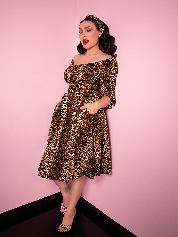 Micheline Pitt showing off the pockets on her new leopard print vacation dress from Vixen Clothing.